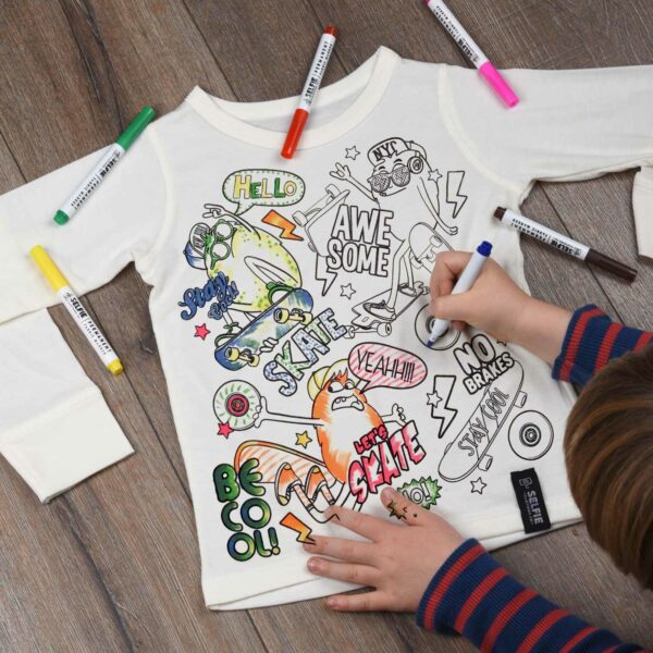 boy colouring in skateboard top with fabric pens